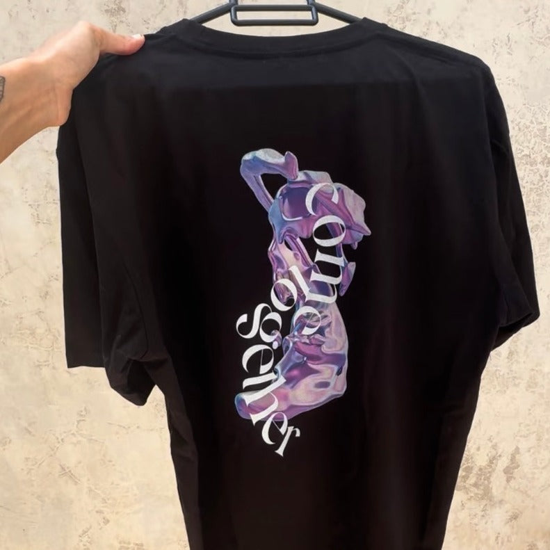 hand holding hanging black t-shirt/graphic tee with pink plasma shape and 'come together' in white curved font vertical style