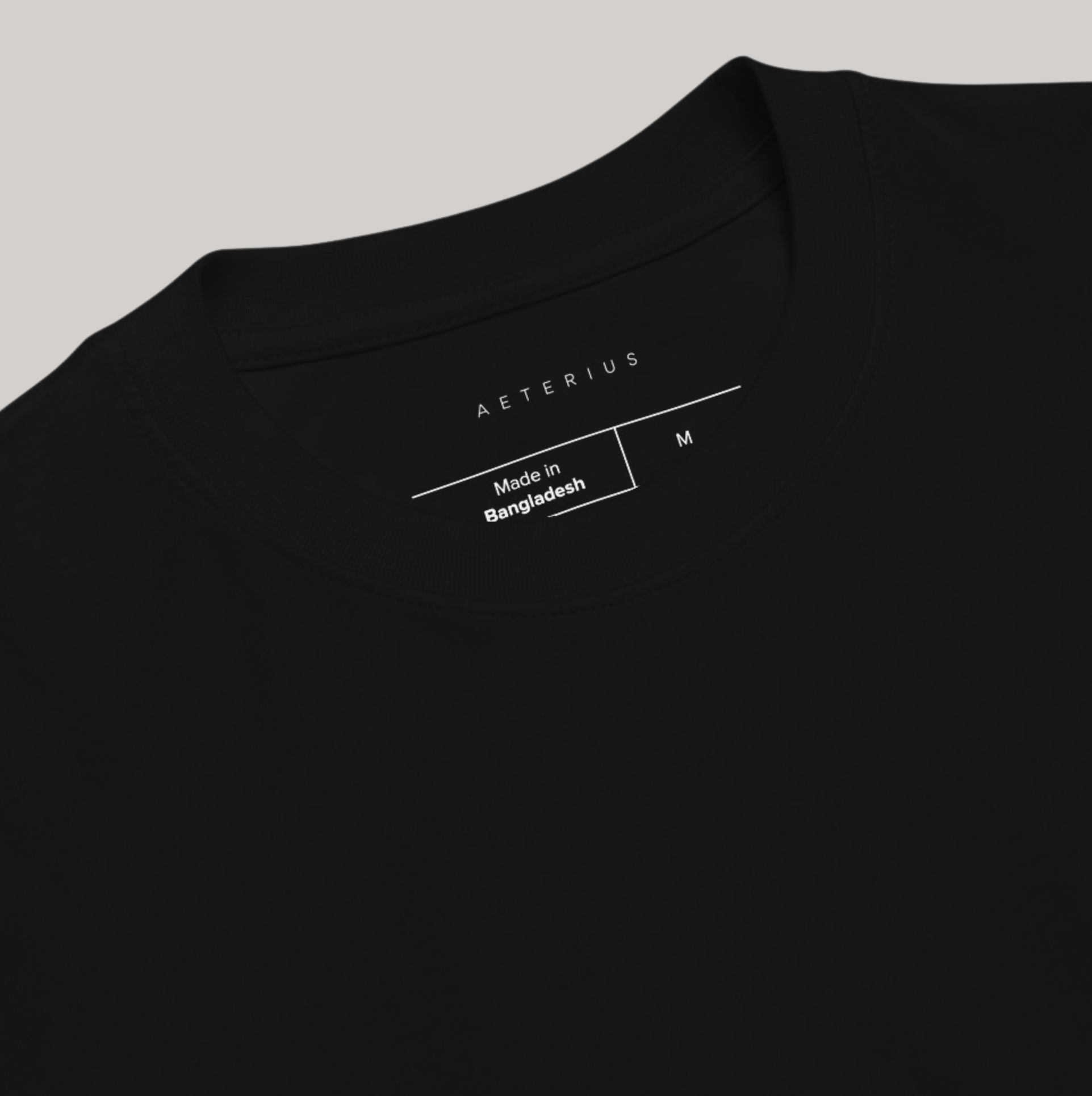 Inside logo of black t-shirt: Aeterius, made in bangladesh, size M tear away label. Round neck crew, 100% combed ring-spun cotton