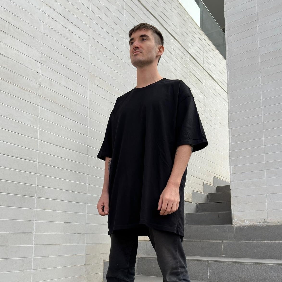 Model wearing full black oversized t-shirt luxury streetwear AETERIUS