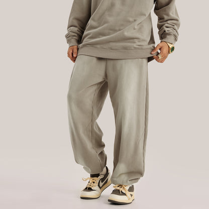 front view of model wearing full beige streetwear fit with beige pants in baggy pants luxury streetwear aesthetic, frontal view