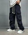 model from abs down in mens black cargo pants with white drawstrings untied, lifting sweatshirt to show cargo pants, cotton material, front view