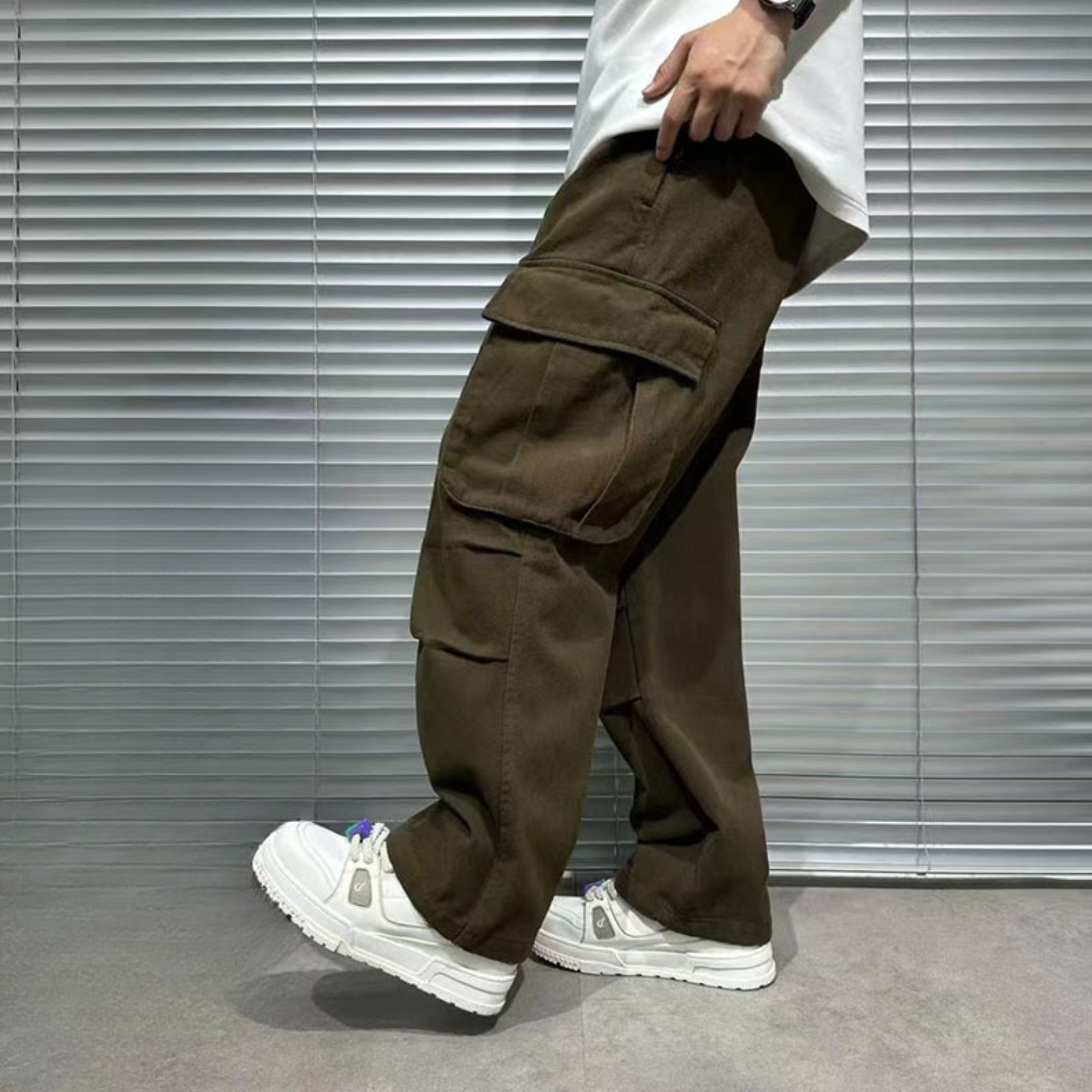 male model's lower body half showing side view of brown cargo pants for men with side pockets