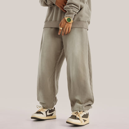 front of model wearing beige baggy pants, streetwear pants oversized in luxury streetwear aesthetic, posing