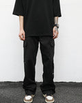 front neutral streetwear model pose wearing luxury streetwear black fit; black cargo pants; drop shoulder black t-shirt