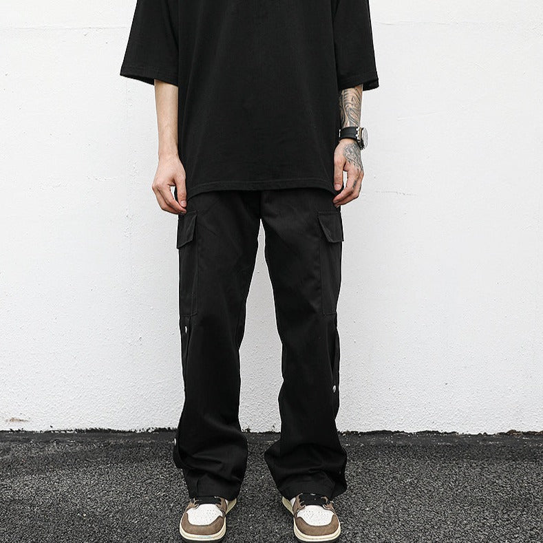 front neutral streetwear model pose wearing luxury streetwear black fit; black cargo pants; drop shoulder black t-shirt