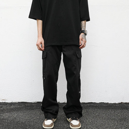 front neutral streetwear model pose wearing luxury streetwear black fit; black cargo pants; drop shoulder black t-shirt