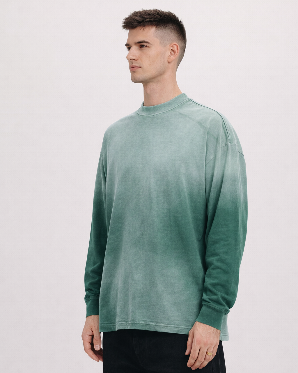 Man wearing a green long-sleeve shirt against a white background