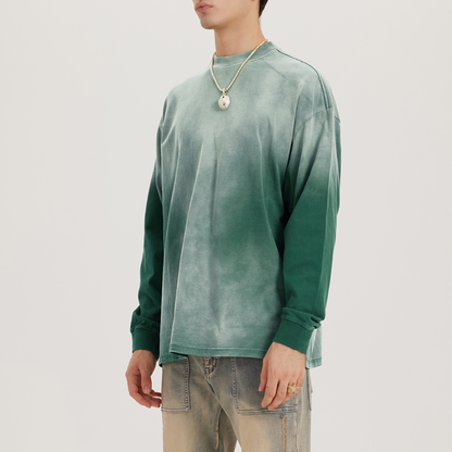 washed faded and dyed green crewneck with long sleeves, model wearing a luxury streetwear crewneck standing diagonally