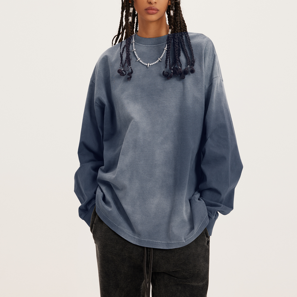 womens oversized crewneck, a long sleeve faded grey crew in streetwear style, model with hands in pockets