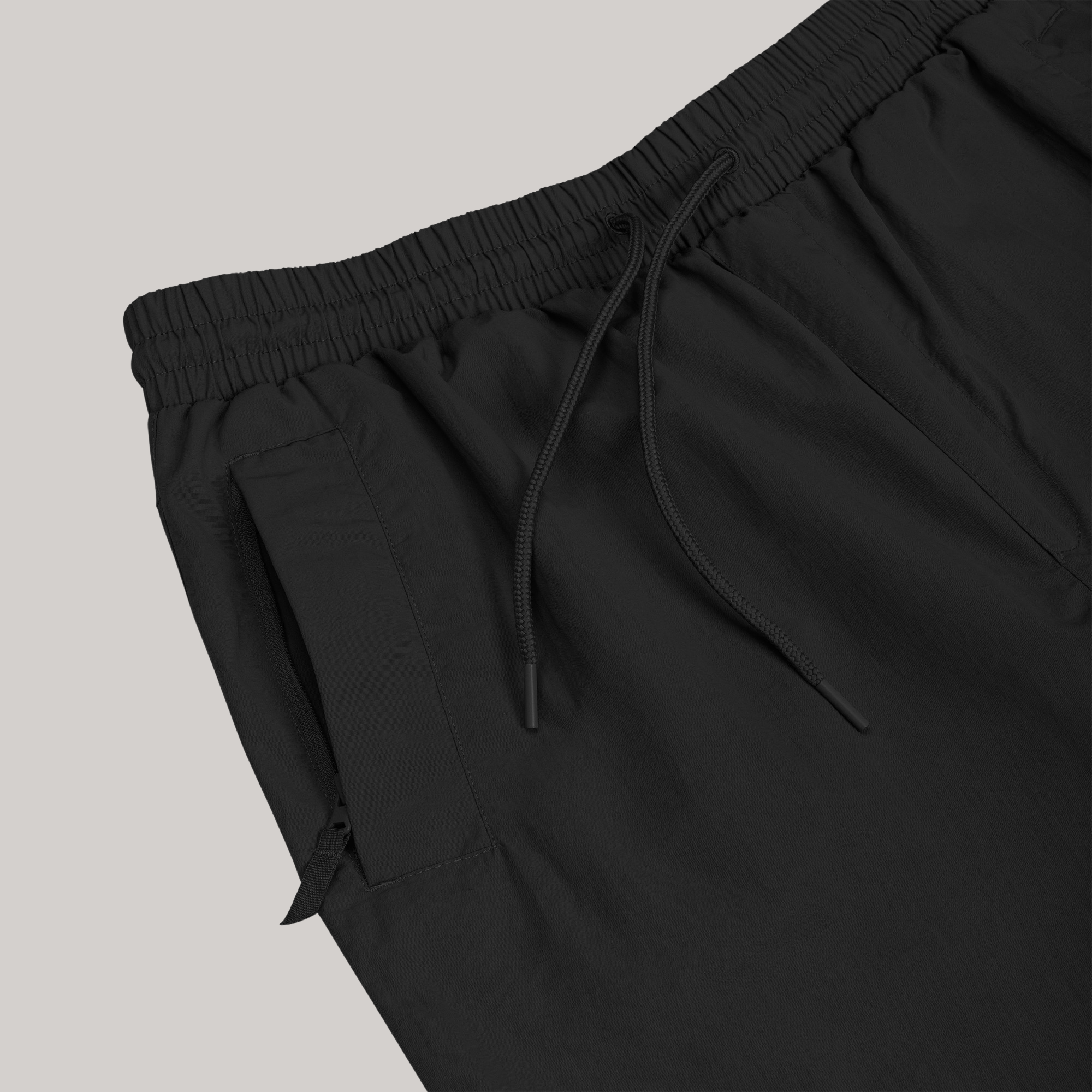 close up ecological tracksuit pants cargo style oversized unisex adjustable elastic waist strings zippered pockets full black
