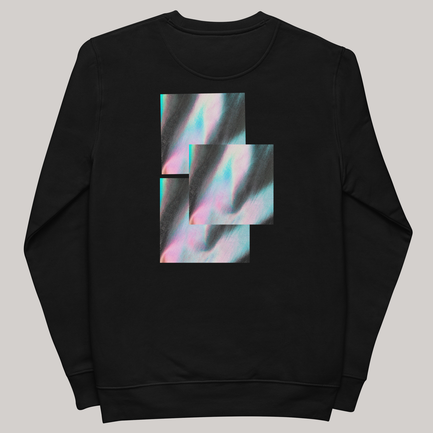 Flat demo of black crewneck: scintillating back print- layered iridescent squares. Organic combed ring-spun cotton, polyester. Crew sweatshirt fit