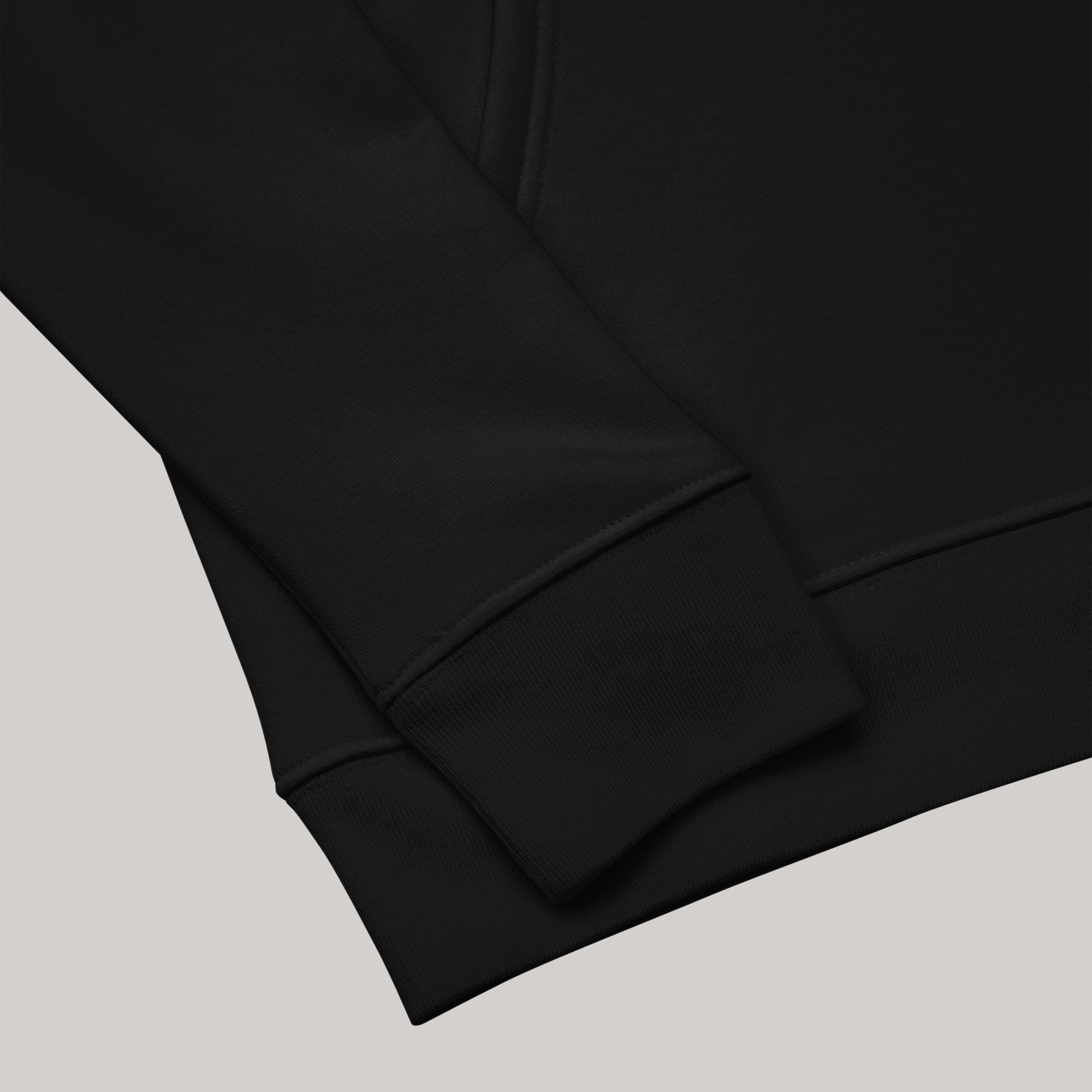 Sleeve and bottom hem of black sweatshirt made of combed ring spun organic cotton