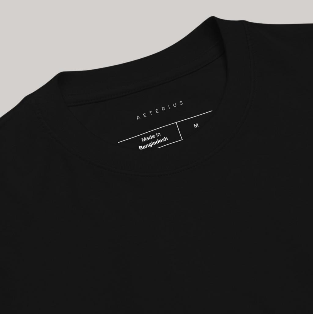 Inside logo of black t-shirt: Aeterius, made in bangladesh, size M tear away label. Round neck crew, 100% combed ring-spun cotton