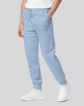 mens light blue joggers in streetwear sweatpants style, hand inside side left pocket, blue drawstrings
