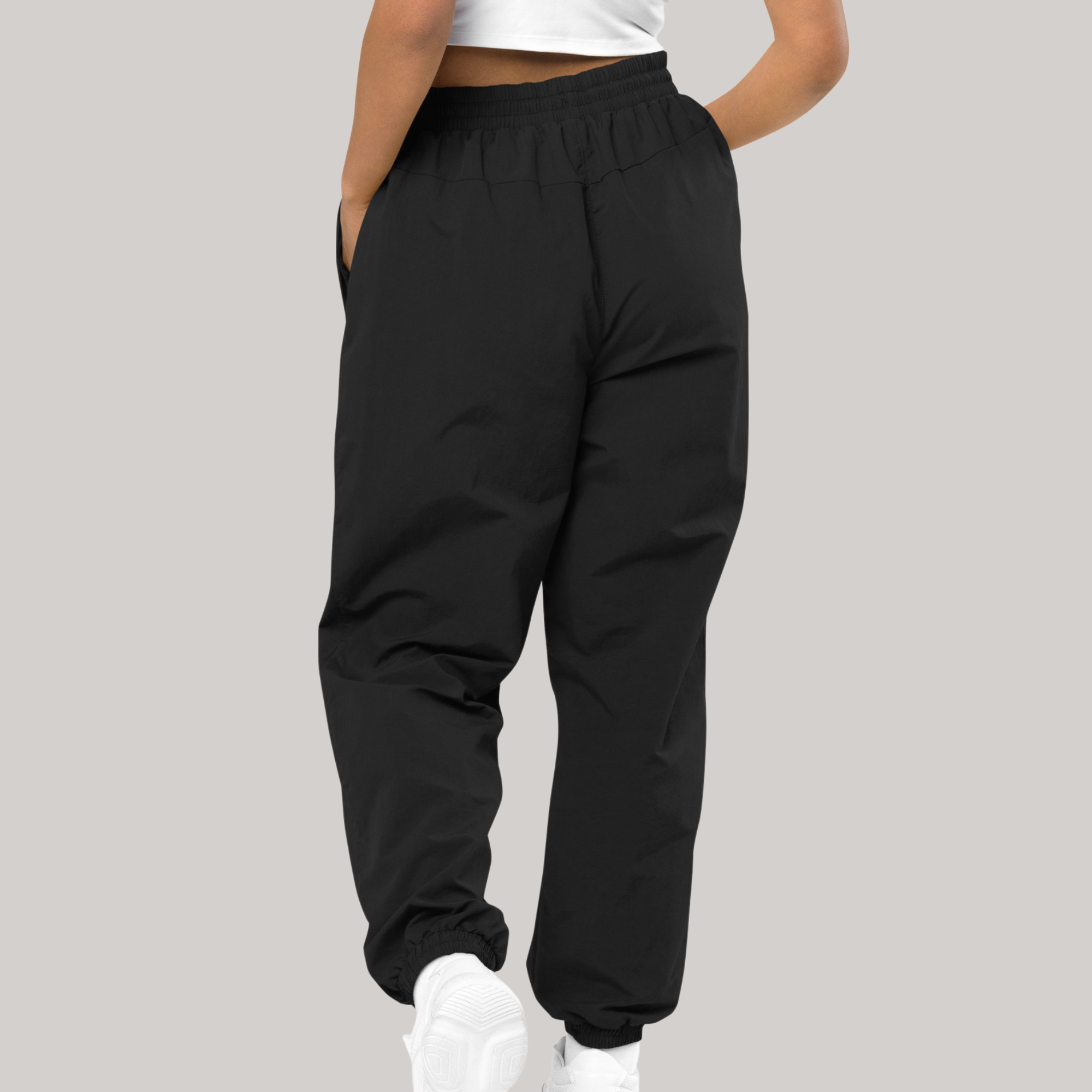 recycled tracksuit trousers cargo pants style 980 back side, female model hands in pockets oversized 