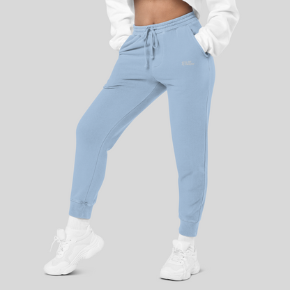lower body half of female model wearing womens light blue joggers with both hands in side pockets, white socks and white shoes in streetwear aesthetic 